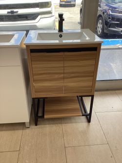 24” vanity wood, metal legs, ceramic top, available for pick up