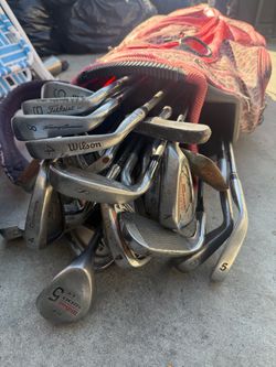 Lot of used golf clubs and golf bag