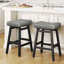 Two leather upholstered saddle bar stools