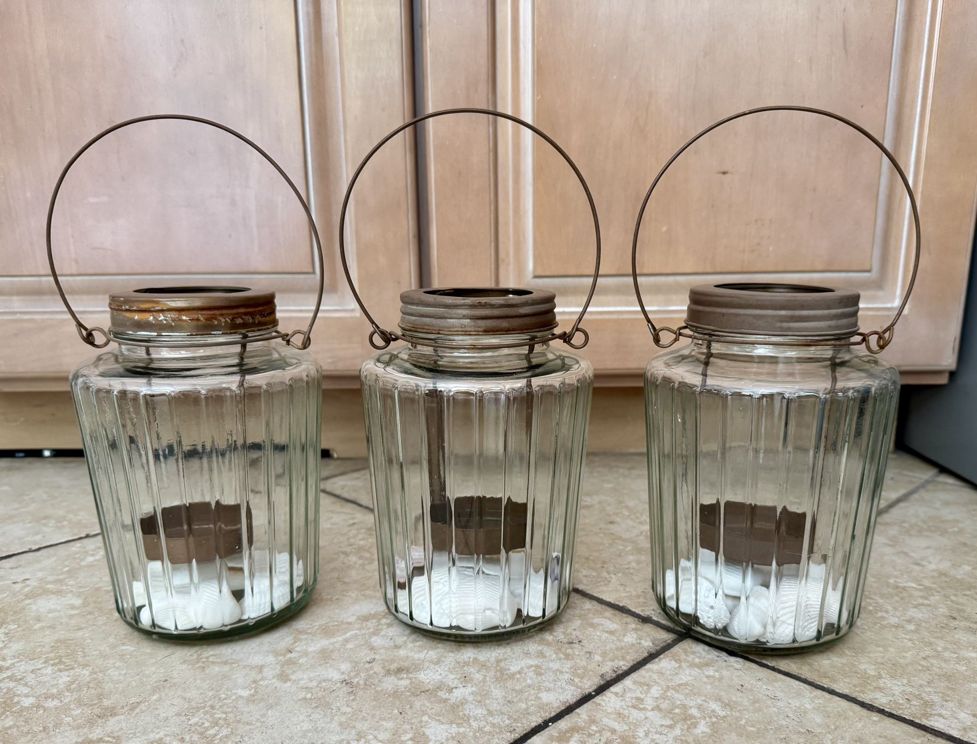 Three outdoor candle holders.