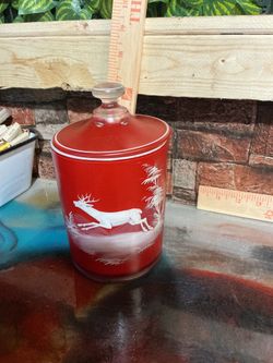 Glass Canister with Lid features a charming red and white reindeer pattern,