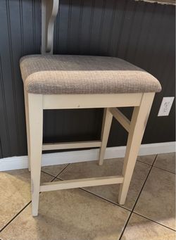 Two Ashley farmhouse counter sized bar stools