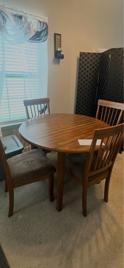 Four piece brown wood dining room table
