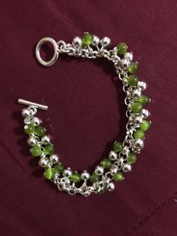 Green and silver colored beaded bracelet