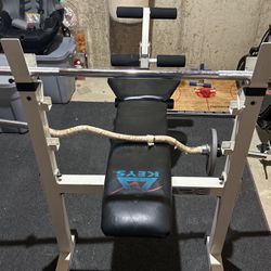 Bench Press With Leg Lift And Curl Bar.