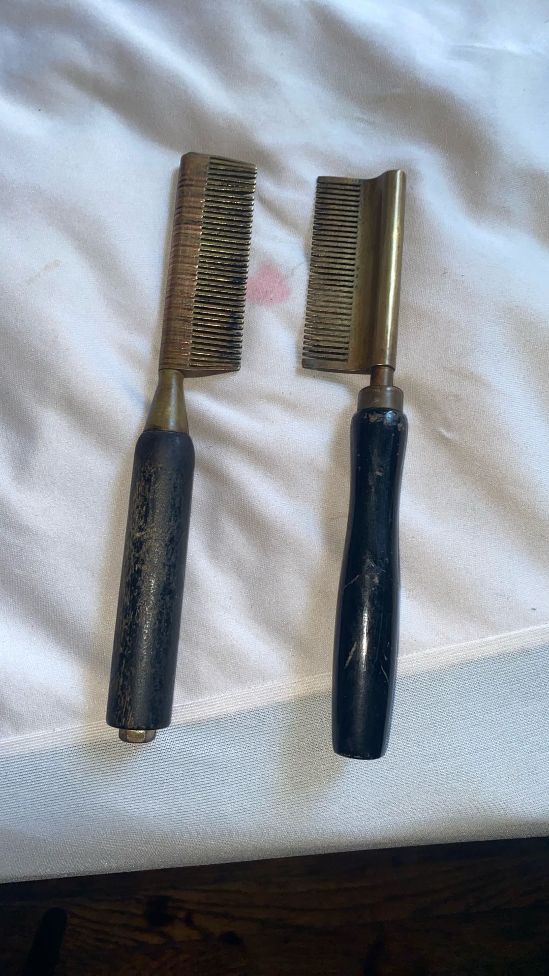 Two antique straightening combs