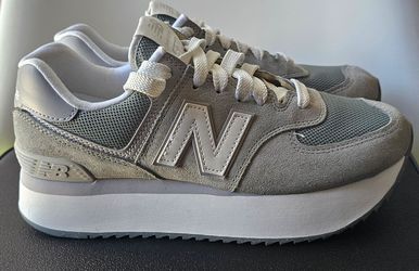 New Balance 574 sneakers, a modified version of the classic 574 featuring a stacked platform sole.Colorway: They are the "Shadow Grey" colorway.Materi