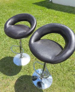 Selling 2 brown leather bar stools