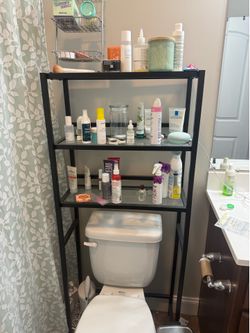behind the toilet shelf