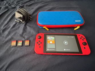 Limited Edition Mario Red Nintendo Switch with dock, games, and a case