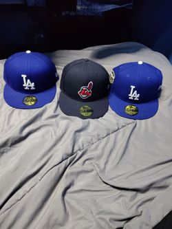 Blue dodgers hat a blue world series dodgers hat and a red Indian hat