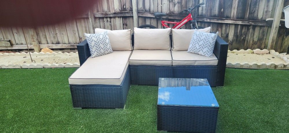 Out door Sectional Lounge with glass top coffee table.