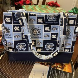 North Carolina University Purse.  Brand New With Pockets For Cell Phone, Lipstick, Etc…nice Purse With Plenty Of Room. Has A Snap To Close.  $30