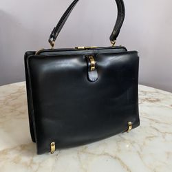 Vintage calf skin leather bag with gold colored hardware. Circa 1950. Red leather lining. Beautiful bag. 