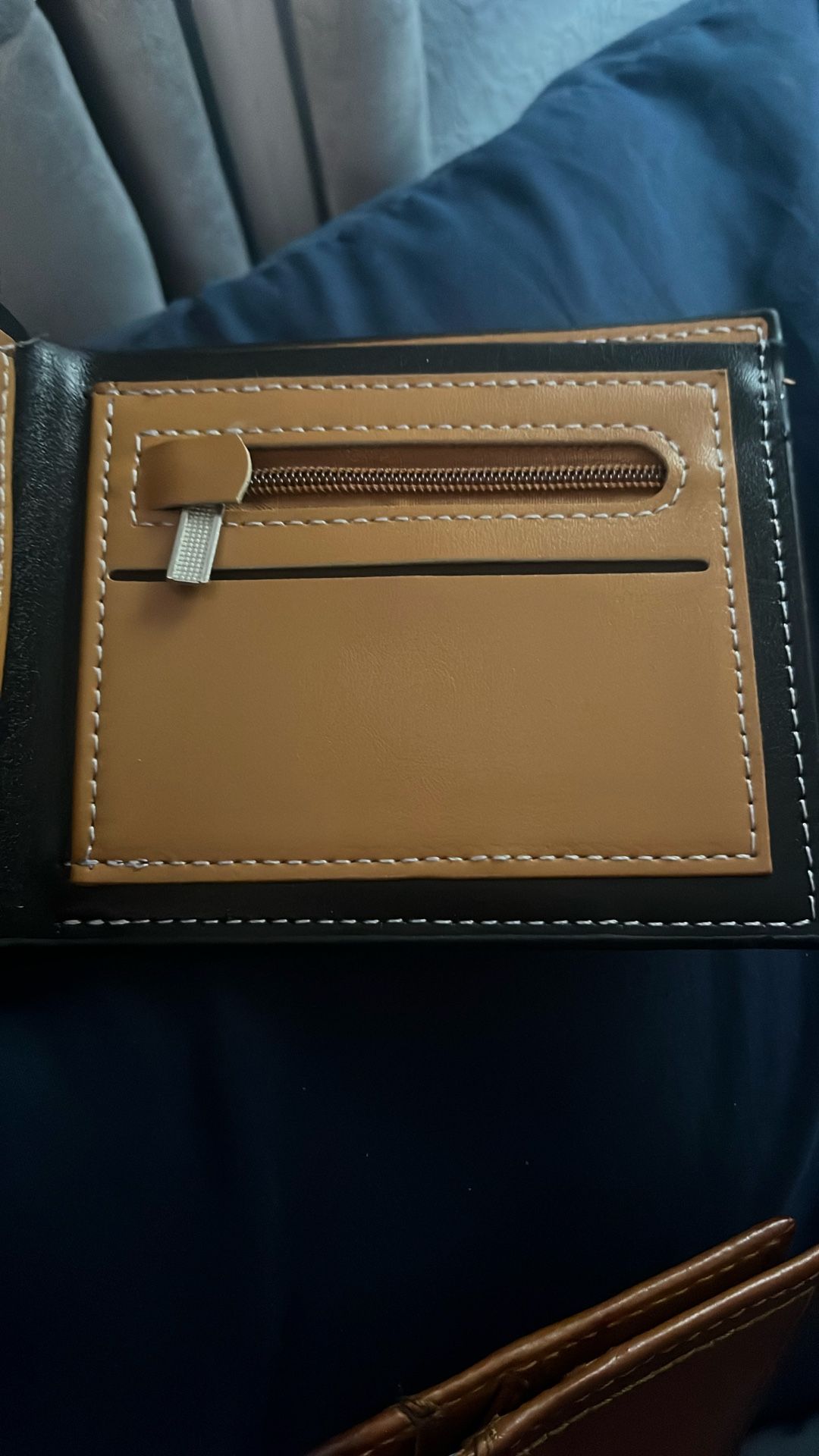 black wallet with brownish on the inside has good pockets for money.