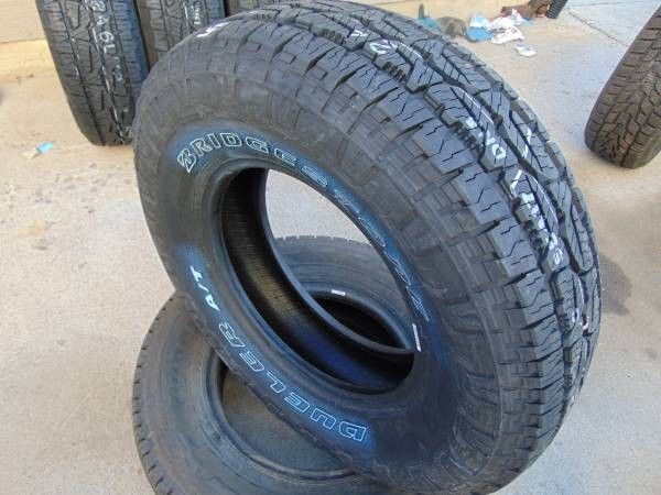 245 75 16 Bridgestone Dueler A/T Revo3 Tires  Outlined White Letters 4PLY  Date 2024
