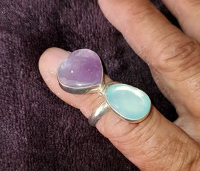 This is the "Luminous Harmony" sterling silver wrap ring featuring a pairing of pastel blue chalcedony and purple amethyst gemstones.