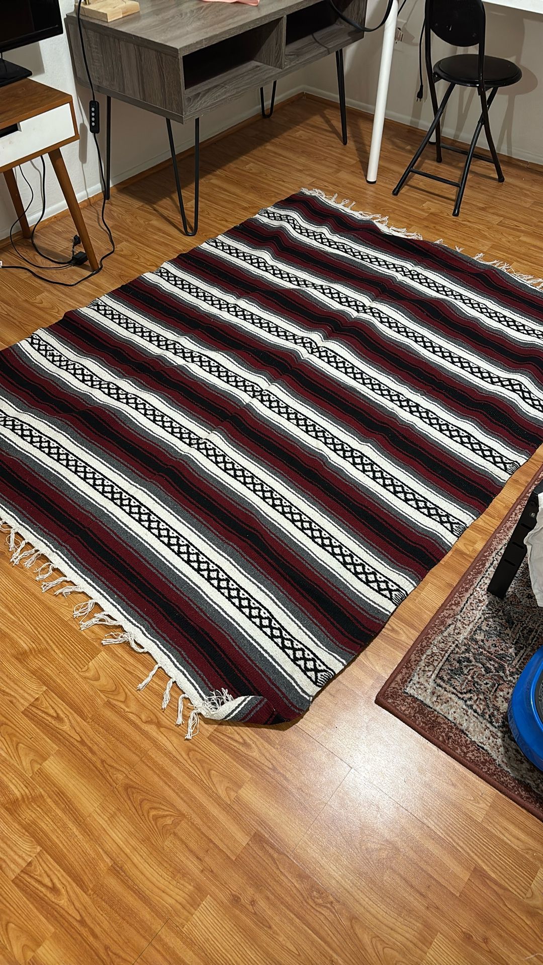 Vintage Mexican serape blanket in red, white, black, and grey stripes