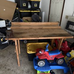 Wooden work bench with clamp