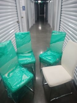 FOUR IVORY WHITE LEATHER DINING CHAIRS