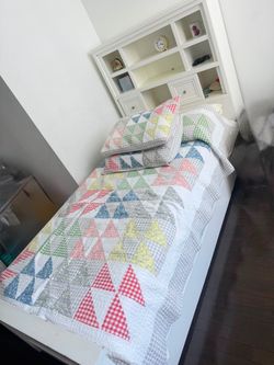 Two white wooden twin beds.