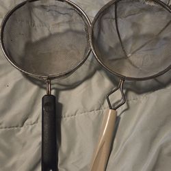 vintage, hand-held mesh strainer, a common kitchen utensil