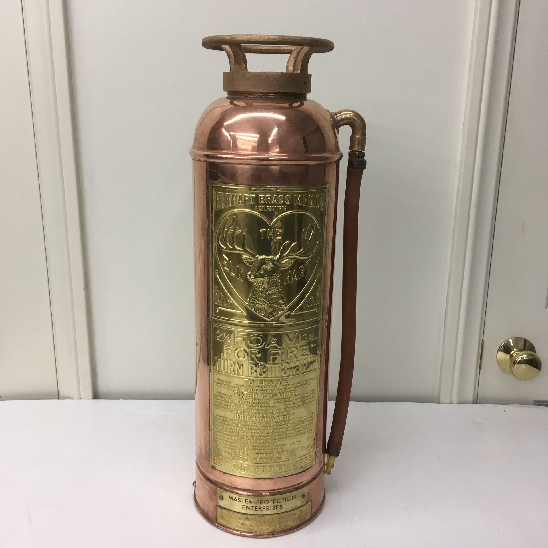 The elkhart vintage cooper and brass foam fire extinguisher. This is the large elk head. Very hart to come by