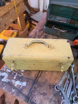 vintage yellow metal toolbox, likely from the mid-century era.
