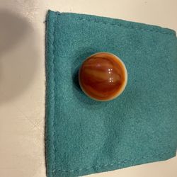 vintage machine-made glass marble, likely a Peltier Rainbo Sunset model featuring orange and white glass.