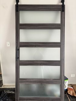 Gray sliding barn door with five frosted-glass panels
