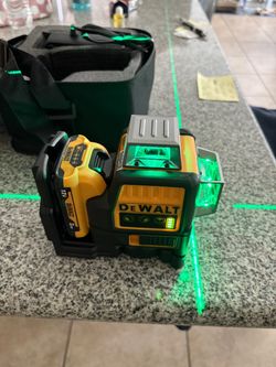 Dewalt laser level with the 12 volt battery and the charger and case