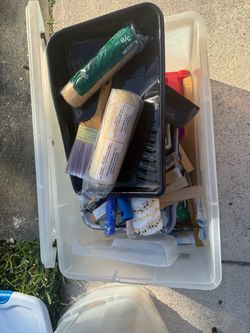 Container full of paint brushes rollers and all kinds of paint stuff