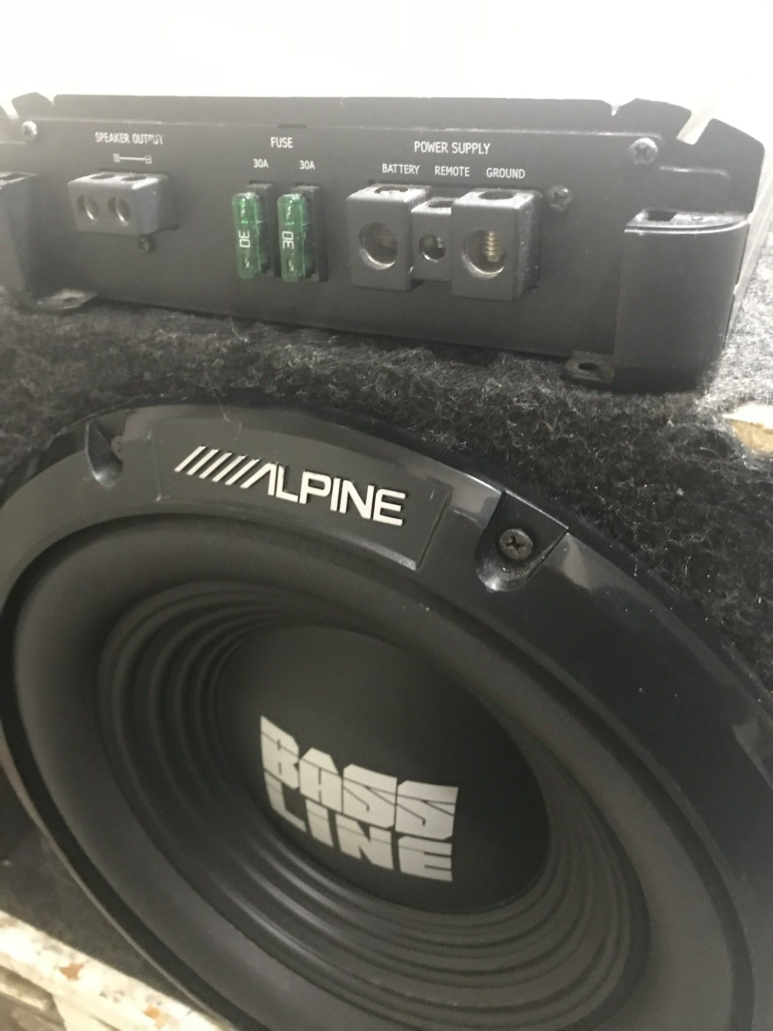 (2) Two Alpine 1000watt Bassline 12s in slot ported box and Alpine D Class M500 amplifier