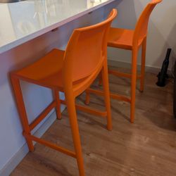 Two Orange Bar Stools