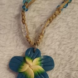 Charming Shark Surf Jewelry Braided & Beaded Fimo Flower Necklace with white/clear and blue beads. Has loop and button closure