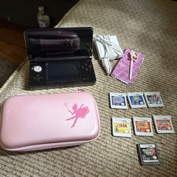 Nintendo 3Ds with seven games cartridges and a couple on the device already