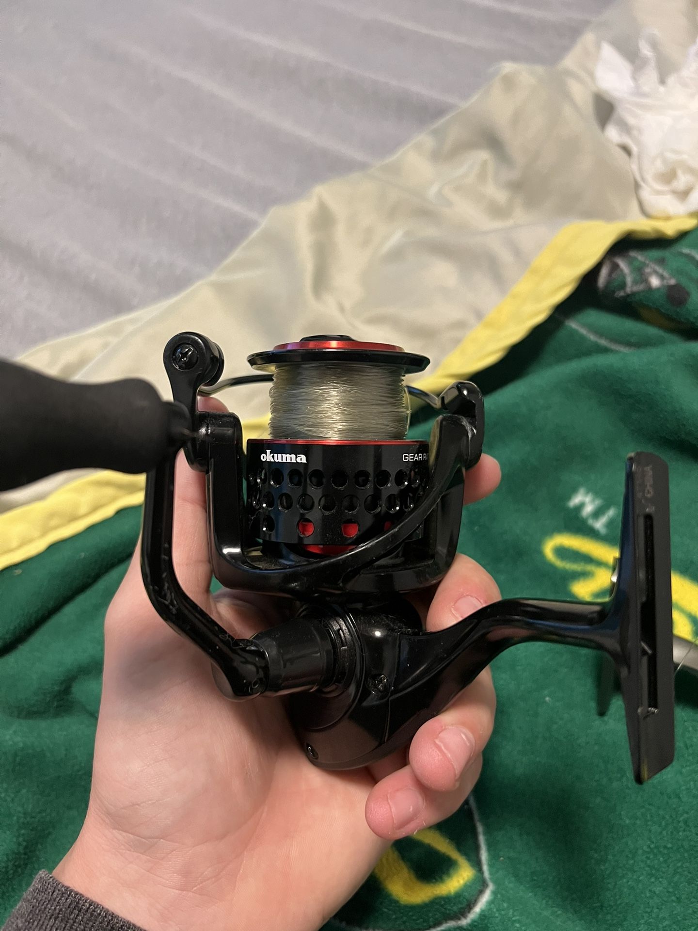Red And Black Okuma Fishing Reel