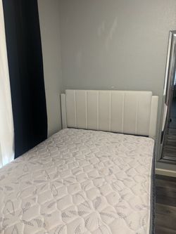 Full Bed with White Upholstered Headboard and Mattress