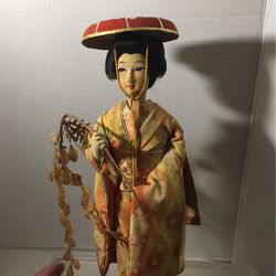 Vintage geisha Japanese doll with branch