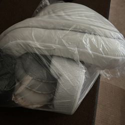 Newborn baby girl clothes along with a doc and other baby items