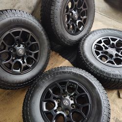 16" TOYOTA FACTORY BLACK WHEELS WITH SEMI NEW TIRES