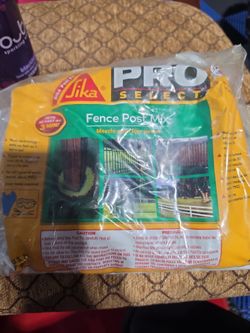 a pouch of Sika Pro Select Fence Post Mix, a mix-in-the-bag expanding foam used to set non-structural posts.