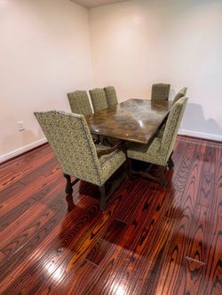 Gorgeous Rectangular dining table with a dark wood parquet-style top and ornate carved trestle base, 8 high-back upholstered chairs -103” x 54”