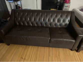 Brown leather couch and ottoman
