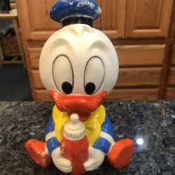 Vintage Disney Baby Donald Duck Soft Rubber Squeaky Toy with a bottle.  Size 8 inches tall.  Preowned.  Year 1984 Walt Disney Company.  Nice edition t
