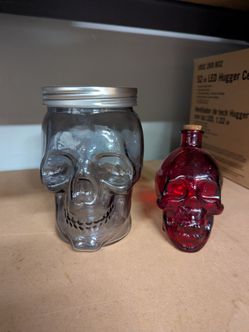 Two skull glass jars