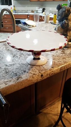 White cake plate with red stripes on edge and penquin