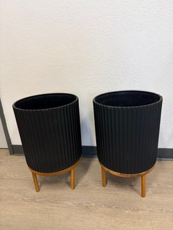 Large black plant pot with stands