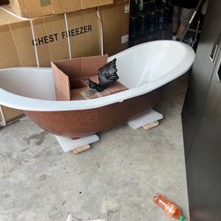 Builder liquidation claw foot Cast iron/porcelain bathtub with brass faucet & drain.