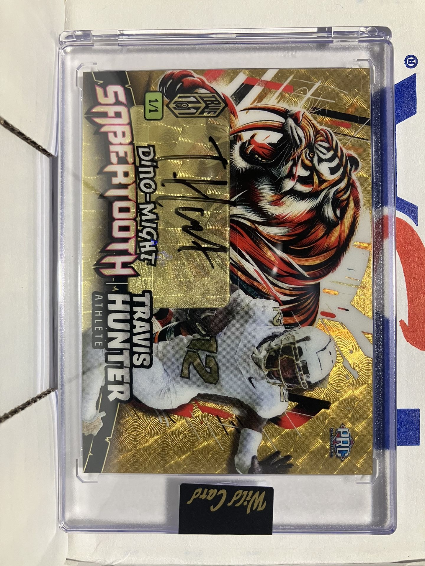 2024 Wild Card Football Dino Might Travis Hunter Saber Tooth Gold Autographed Numbered #1/1 Rookie Card PHST-THA This card is in Very Good Condition.